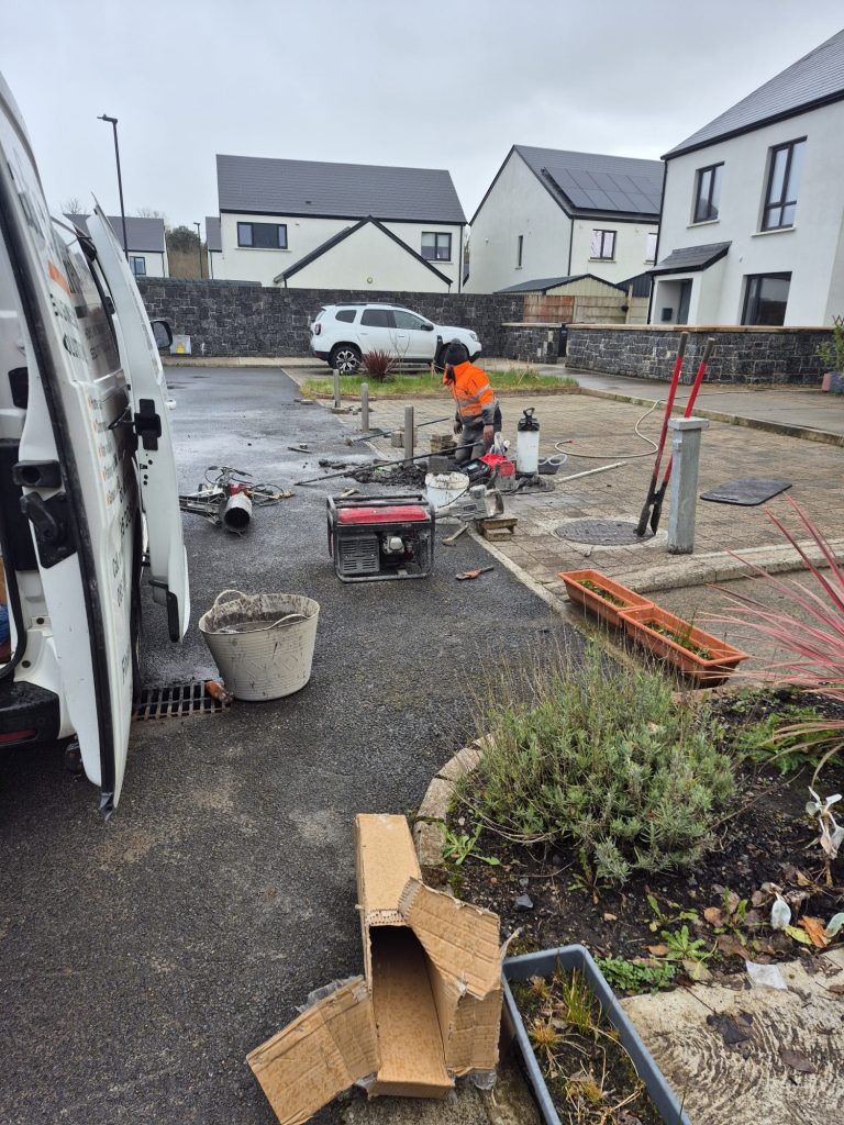 Groundworks and concrete setting for heavy duty telescopic parking posts at a commercial facility.